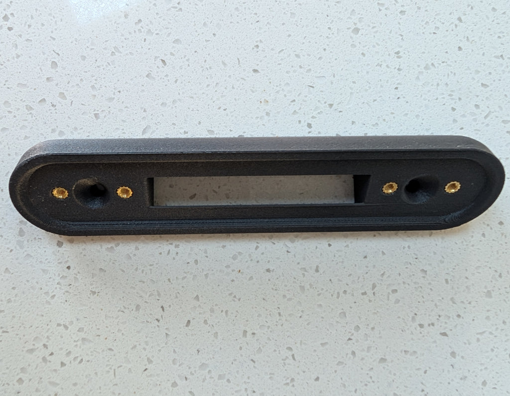 Google Nest Doorbell (Battery) Reversible Angle Mount, in grey. Unmounted on worksurface.