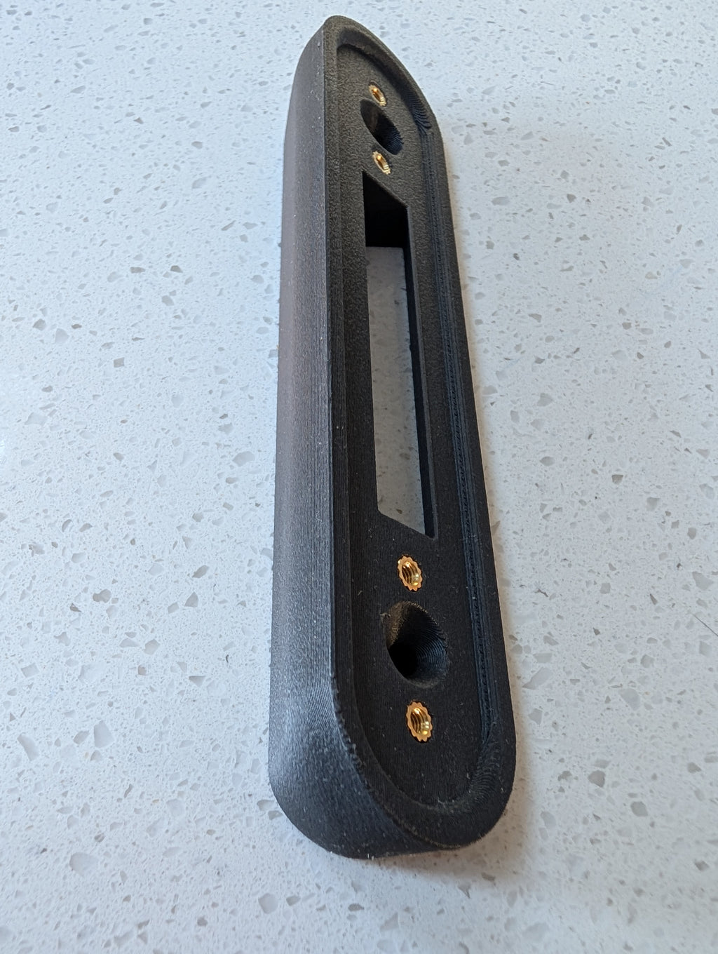 Google Nest Doorbell (Battery) Reversible Angle Mount, in grey. Unmounted on worksurface.