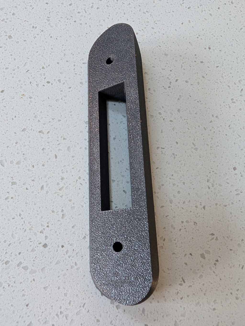 Google Nest Doorbell (Battery) Reversible Angle Mount, in grey. Unmounted on worksurface.