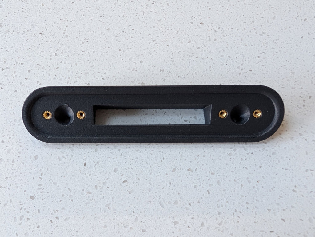 Google Nest Doorbell (Battery) Reversible Angle Mount, in grey. Unmounted on worksurface.