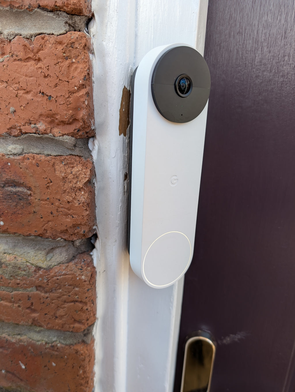 Google Nest Doorbell (Battery) Reversible Angle Mount, in grey. Mounted on door frame.