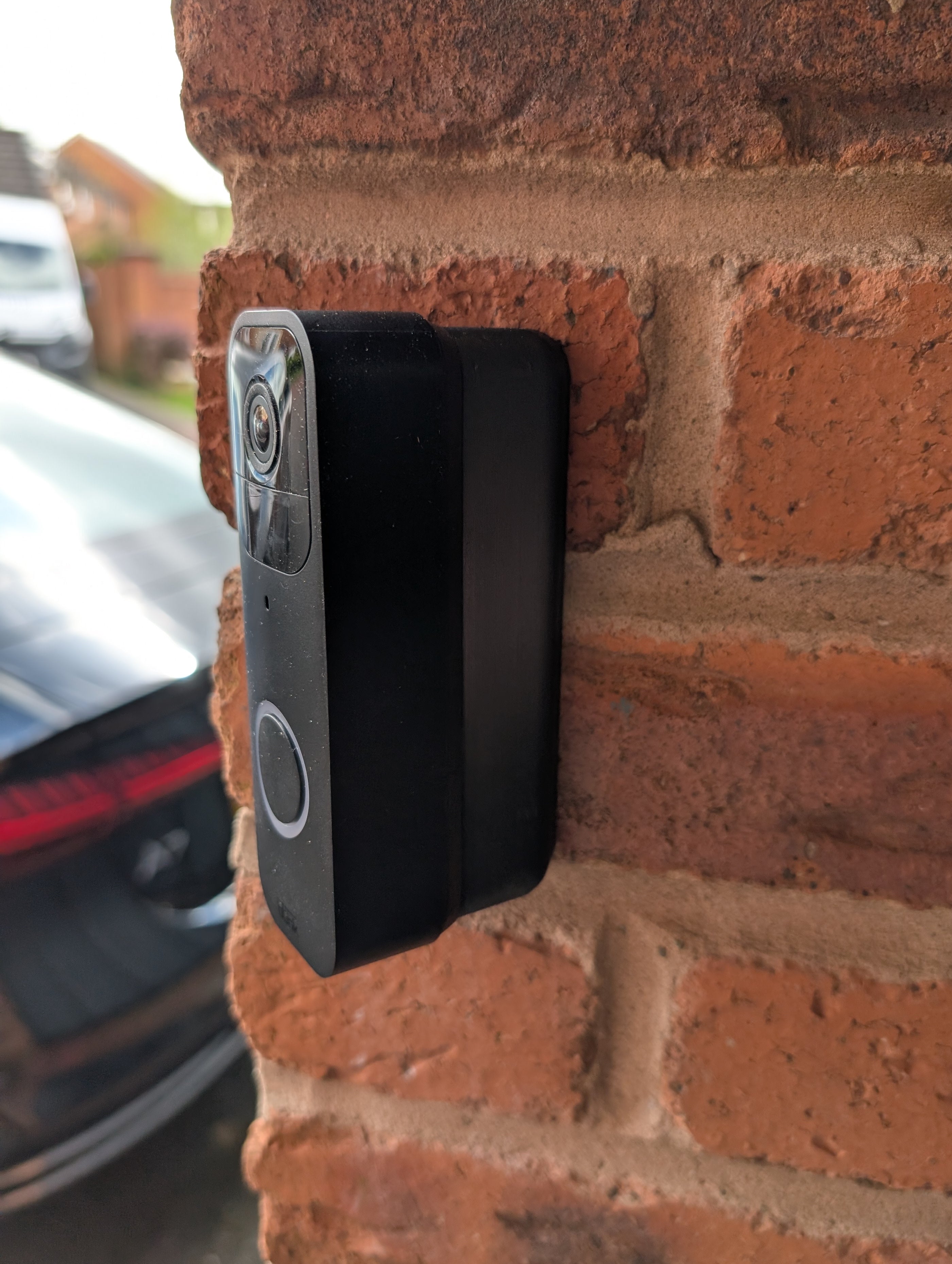Blink Video Doorbell (Version 1) Reversible Angle Mount, in black. Mounted on wall.