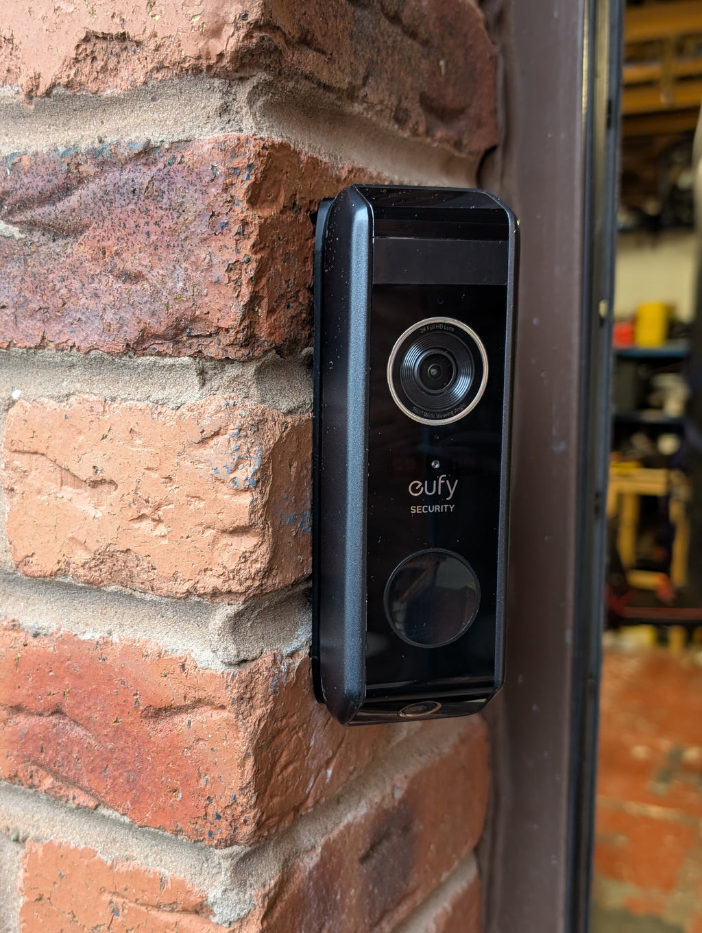 Eufy Video Doorbell Dual S330 Reversible Angle Mount, in black. Mounted on wall.
