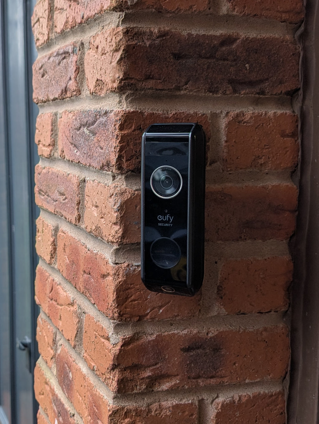 Eufy Video Doorbell Dual S330 Reversible Angle Mount, in black. Mounted on wall.
