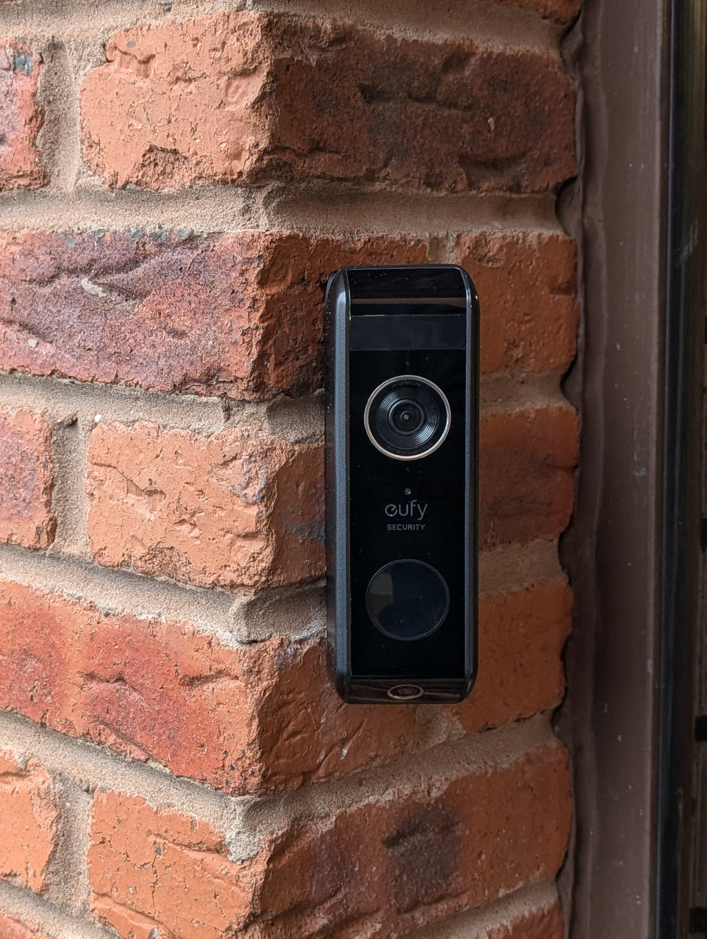 Eufy Video Doorbell Dual S330 Reversible Angle Mount, in black. Mounted on wall.