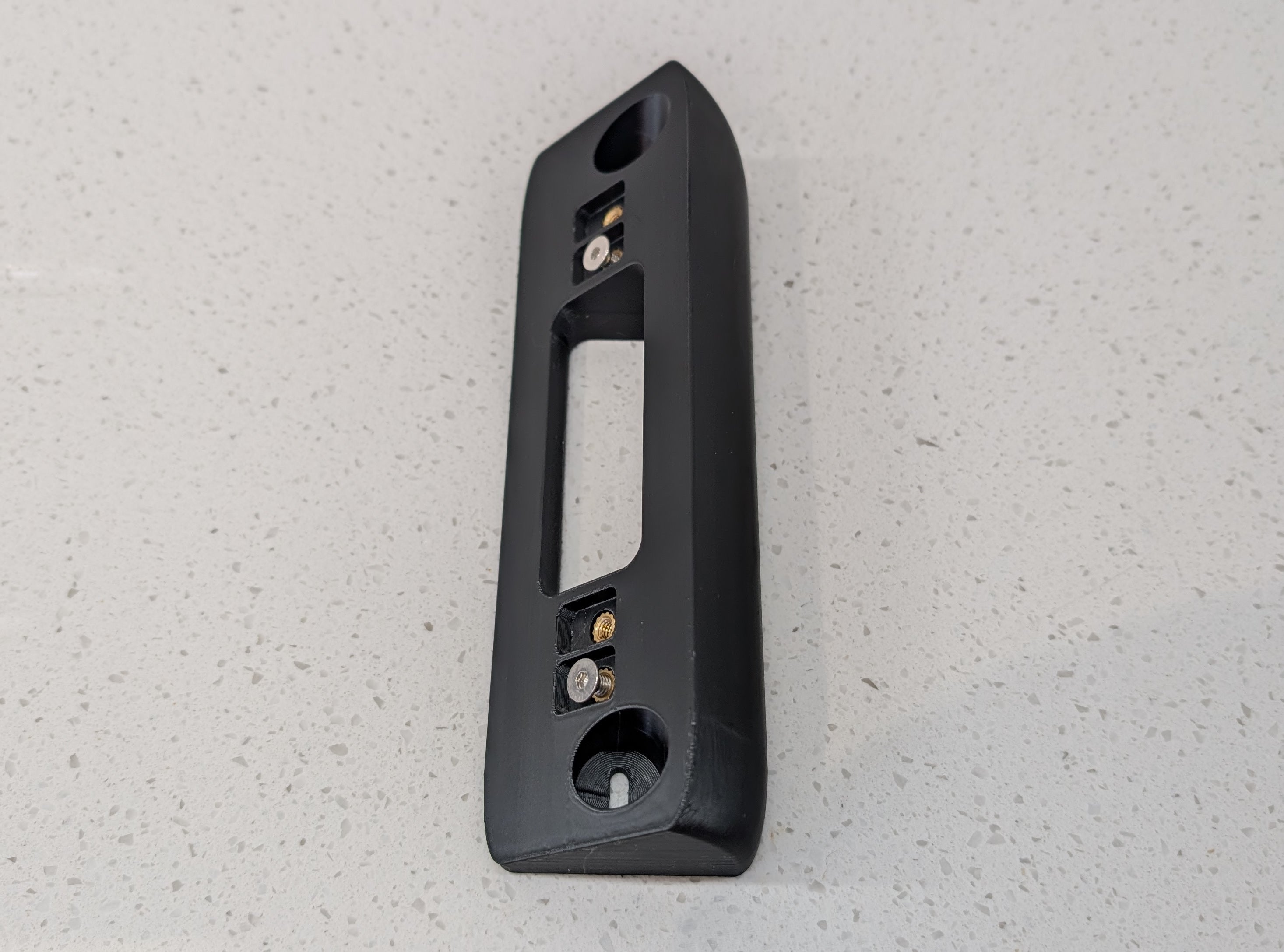 Eufy Video Doorbell Dual S330 Reversible Angle Mount, in black. Unmounted on worksurface.