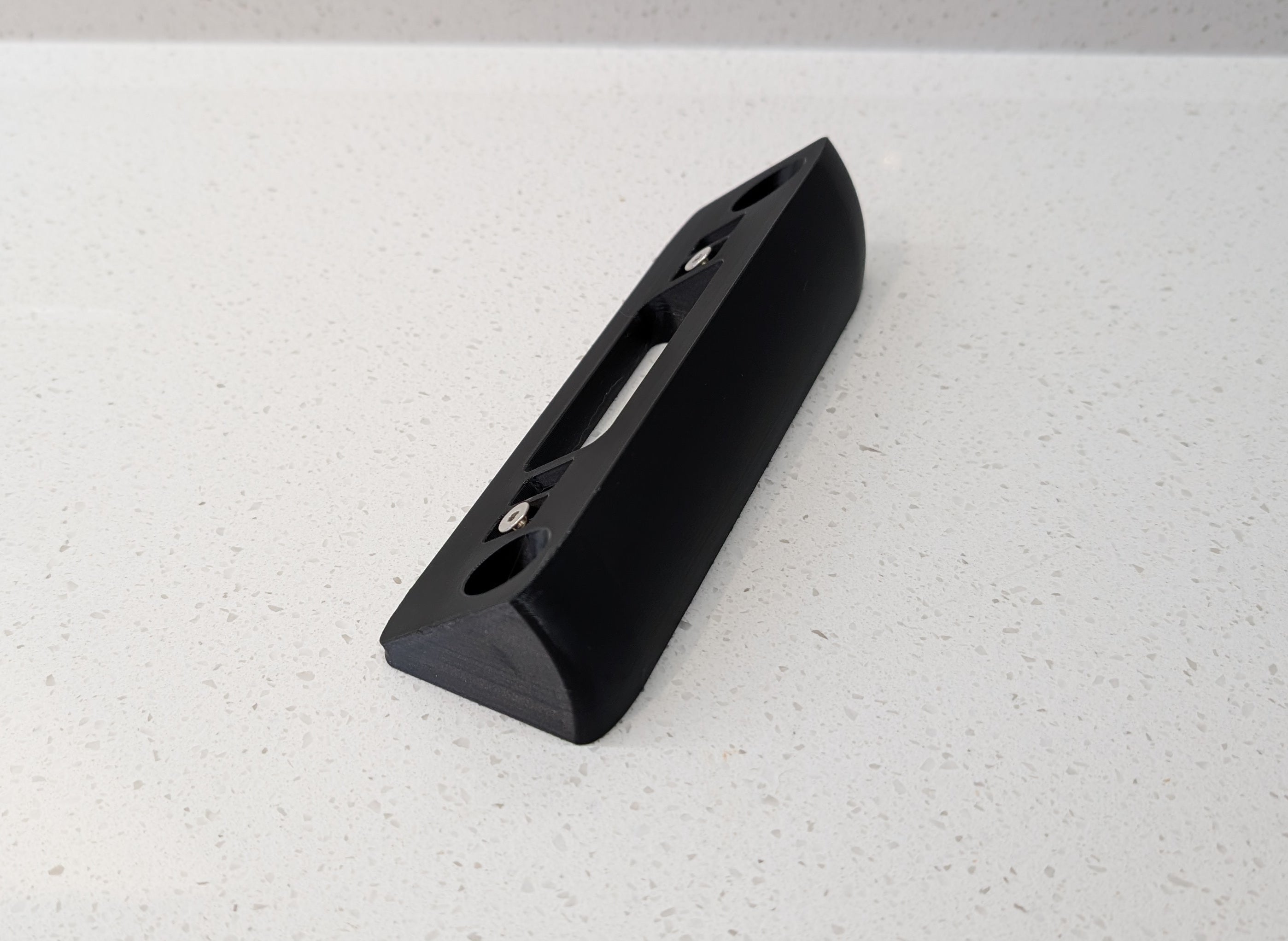 Eufy Video Doorbell Dual S330 Reversible Angle Mount, in black. Unmounted on worksurface.