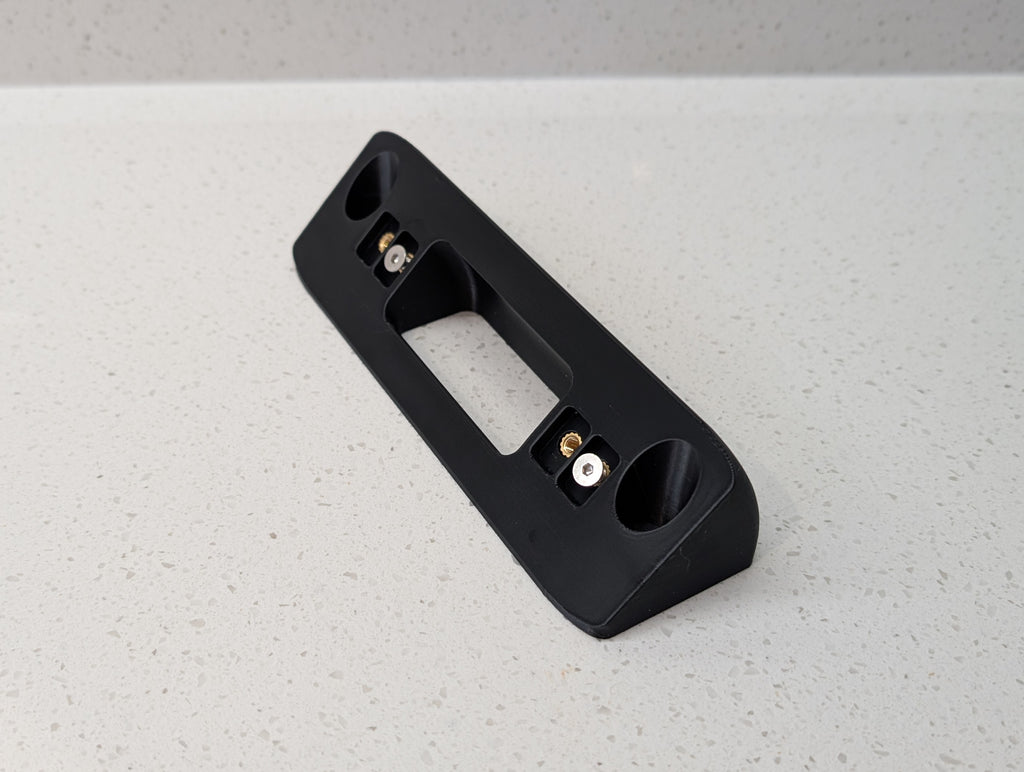 Eufy Video Doorbell Dual S330 Reversible Angle Mount, in black. Unmounted on worksurface.
