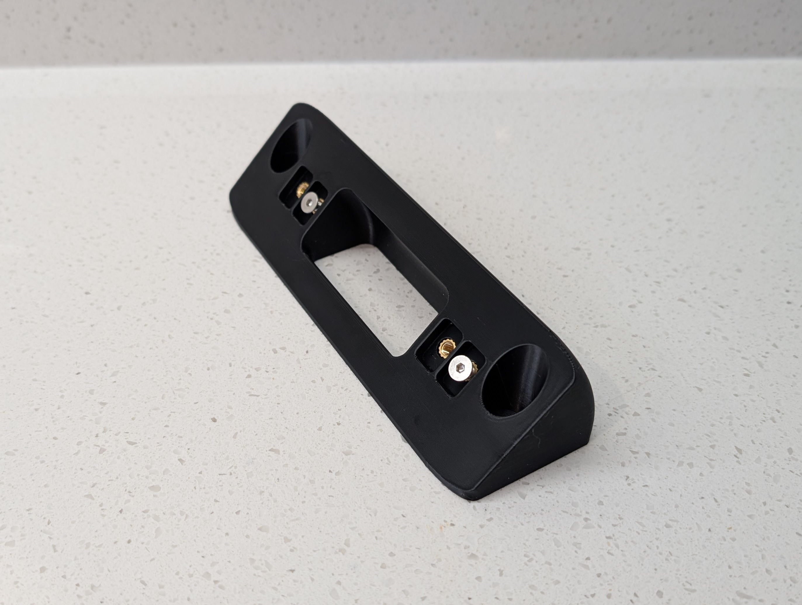Eufy Video Doorbell Dual S330 Reversible Angle Mount, in black. Unmounted on worksurface.