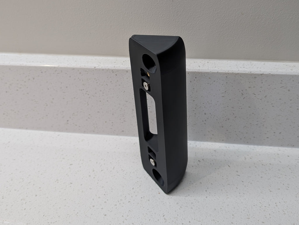 Eufy Video Doorbell Dual S330 Reversible Angle Mount, in black. Unmounted on worksurface.