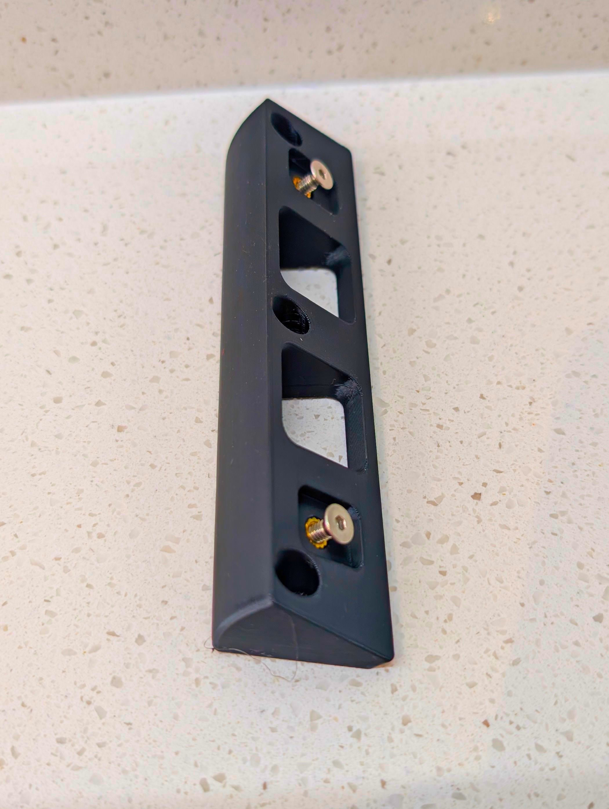 Eufy Video Doorbell E340 Reversible Angle Mount, in black. Unmounted on work surface.