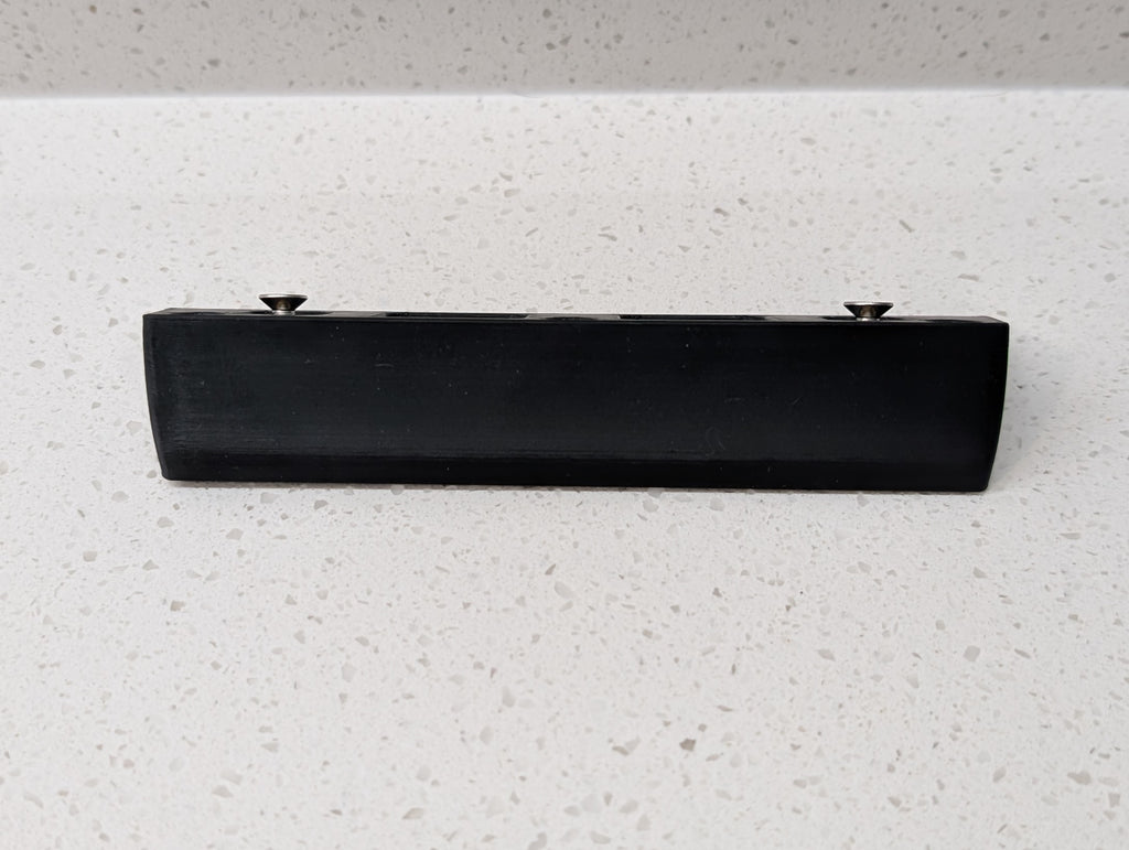 Eufy Video Doorbell E340 Reversible Angle Mount, in black. Unmounted on work surface.