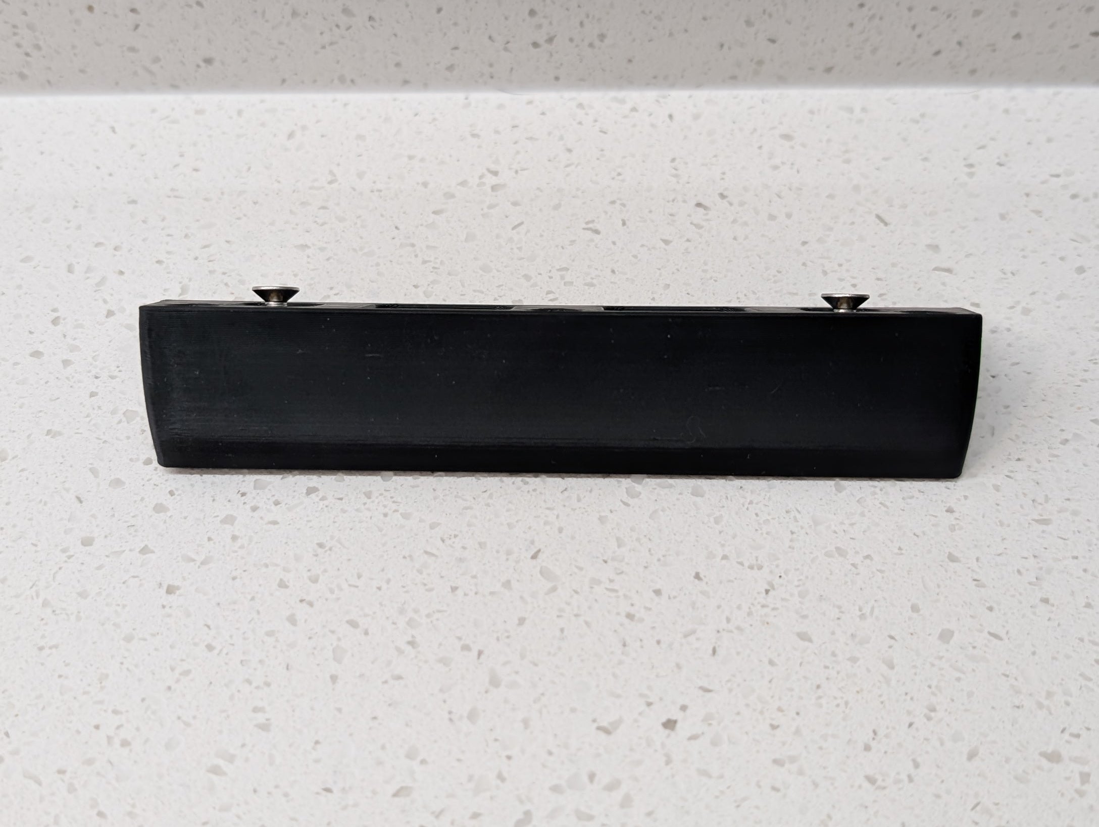 Eufy Video Doorbell E340 Reversible Angle Mount, in black. Unmounted on work surface.
