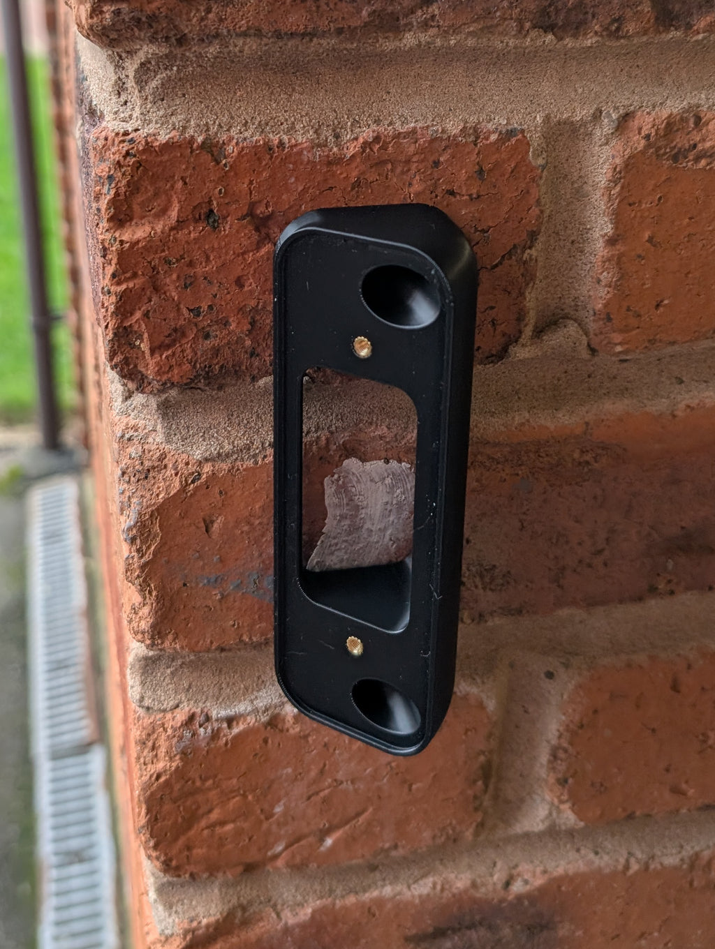 Blink Video Doorbell (2nd Gen) Reversible Angle Mount, in black. Mounted on wall.