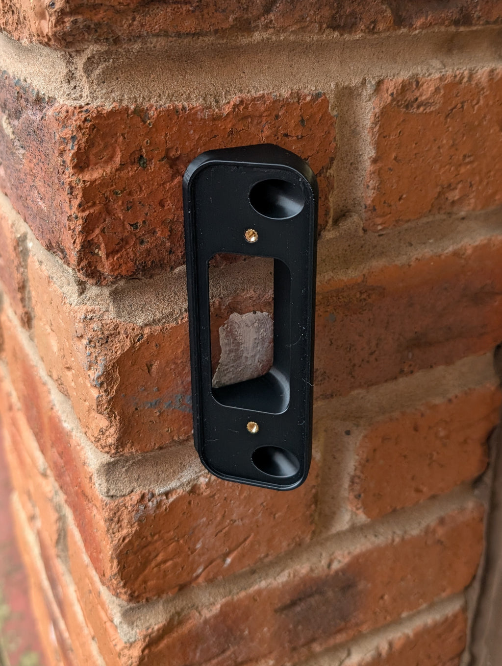 Blink Video Doorbell (2nd Gen) Reversible Angle Mount, in black. Mounted on wall.