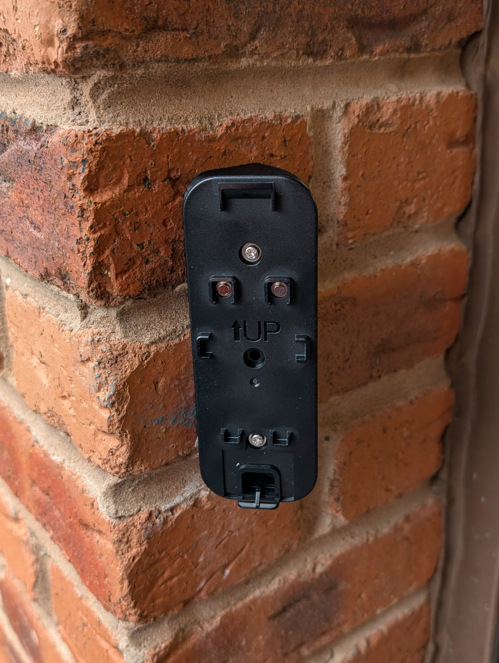 Blink Video Doorbell (2nd Gen) Reversible Angle Mount, in black. Mounted on wall.