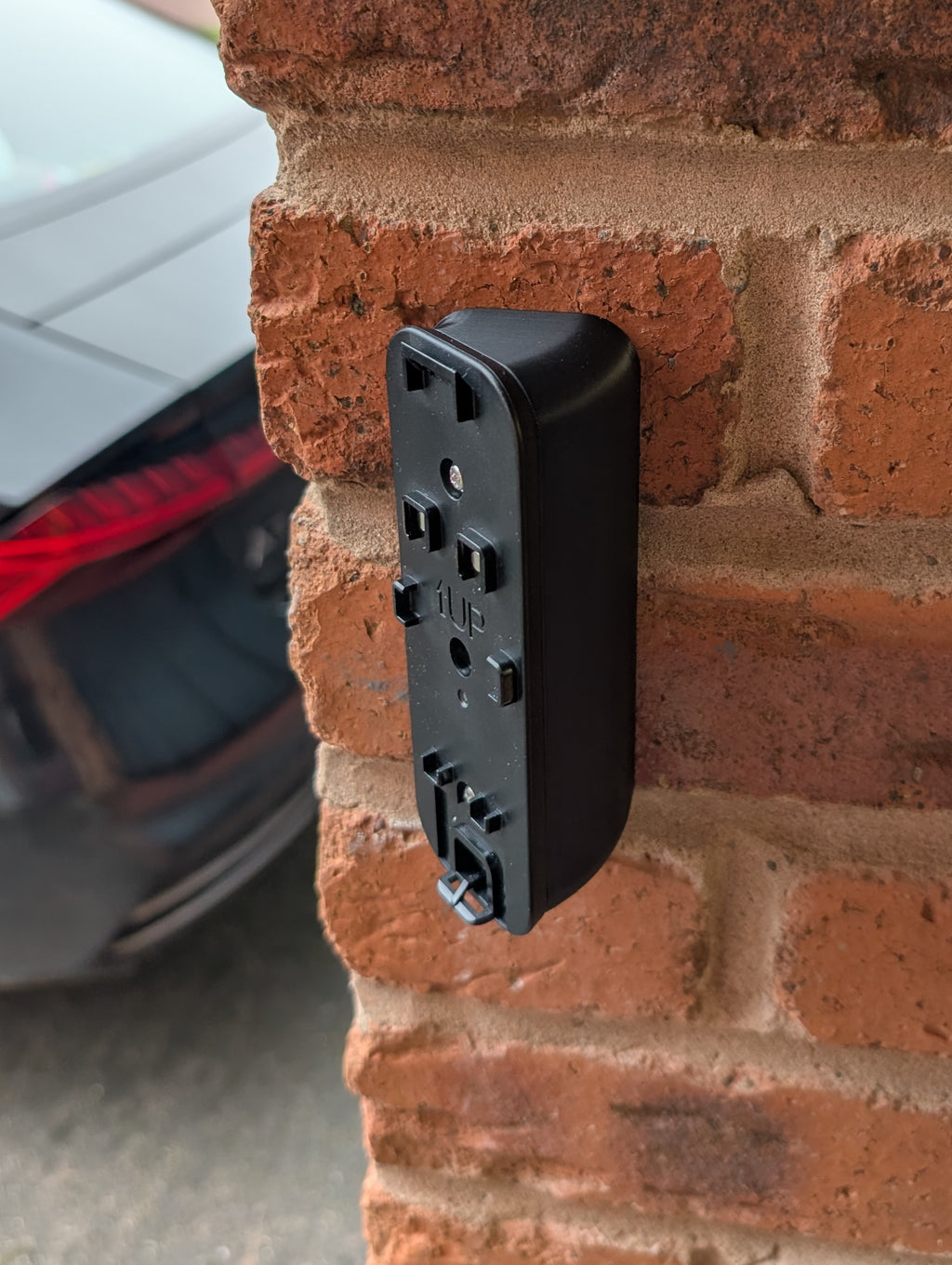 Blink Video Doorbell (2nd Gen) Reversible Angle Mount, in black. Mounted on wall.