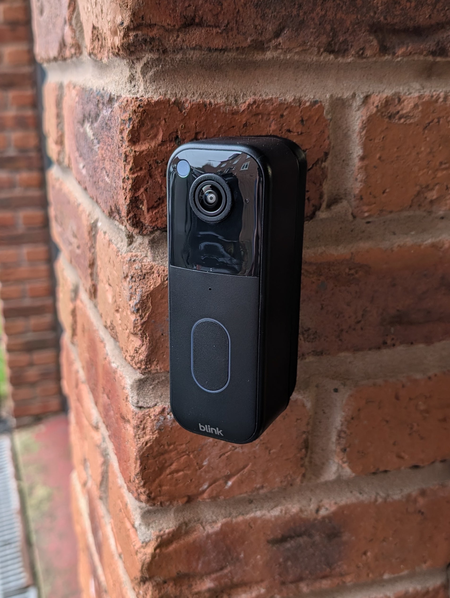 Blink Video Doorbell (2nd Gen) Reversible Angle Mount, in black. Mounted on wall.