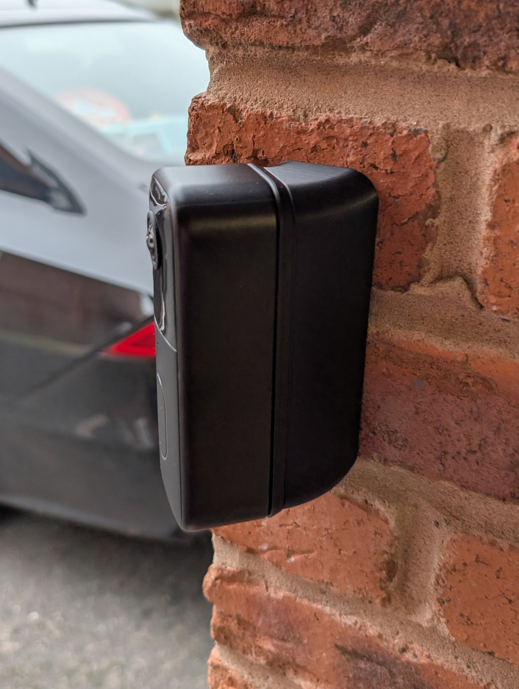 Blink Video Doorbell (2nd Gen) Reversible Angle Mount, in black. Mounted on wall.
