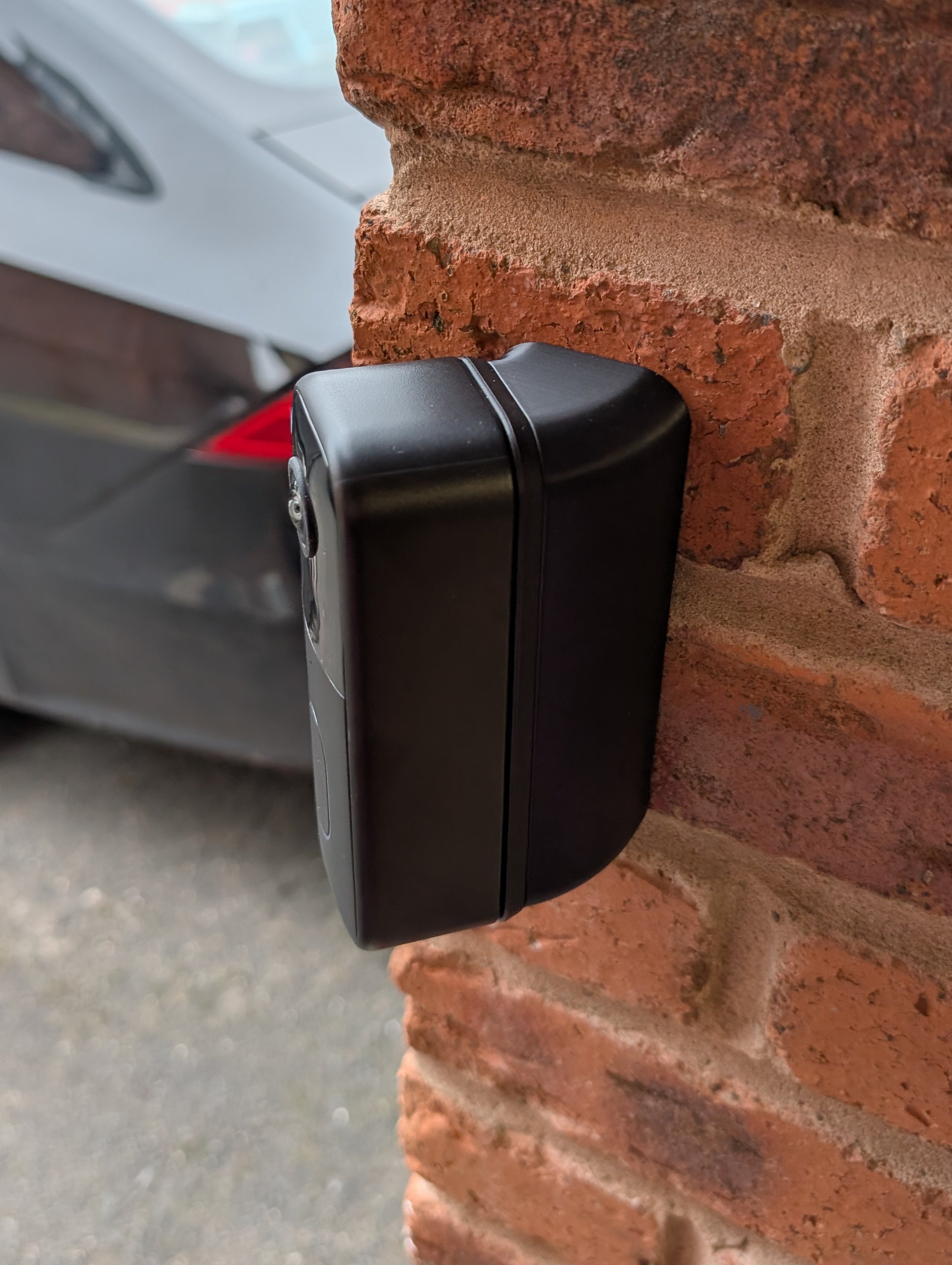 Blink Video Doorbell (2nd Gen) Reversible Angle Mount, in black. Mounted on wall.