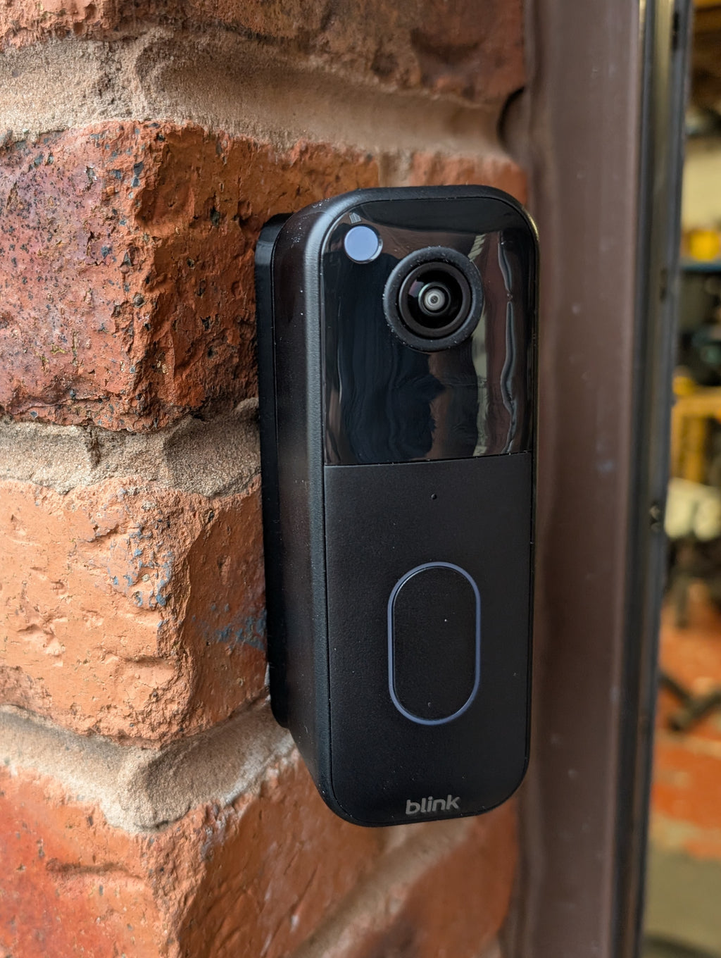 Blink Video Doorbell (2nd Gen) Reversible Angle Mount, in black. Mounted on wall.