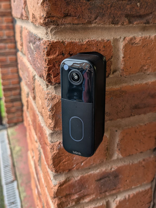 Blink Video Doorbell (2nd Gen) Reversible Angle Mount, in black. Mounted on wall.