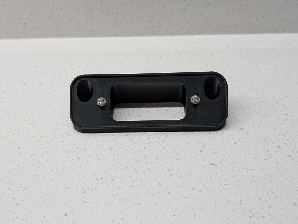 Blink Video Doorbell (2nd Gen) Reversible Angle Mount, in black. Unmounted on work surface.