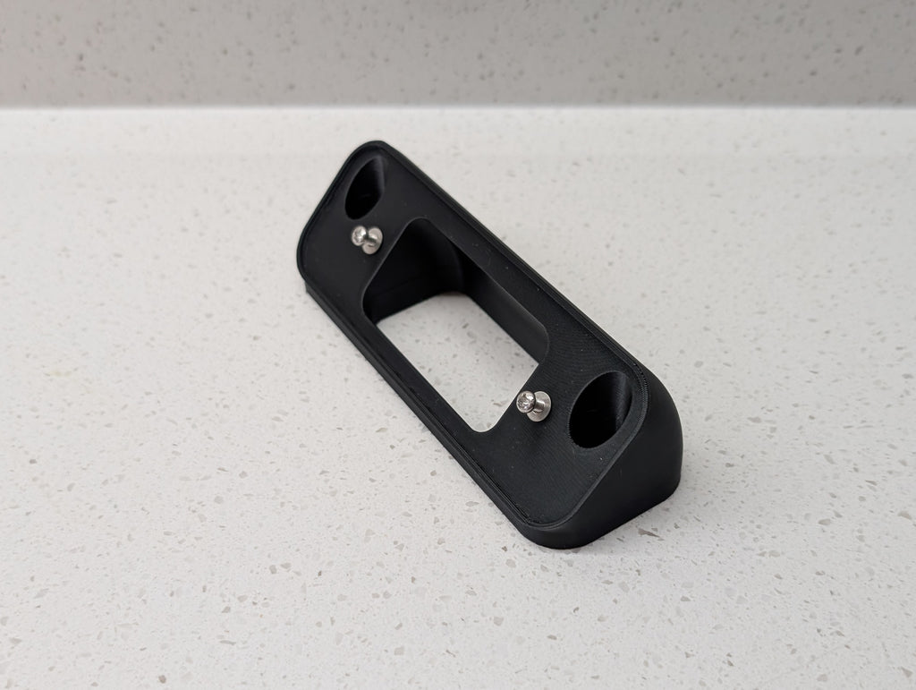 Blink Video Doorbell (2nd Gen) Reversible Angle Mount, in black. Unmounted on work surface.