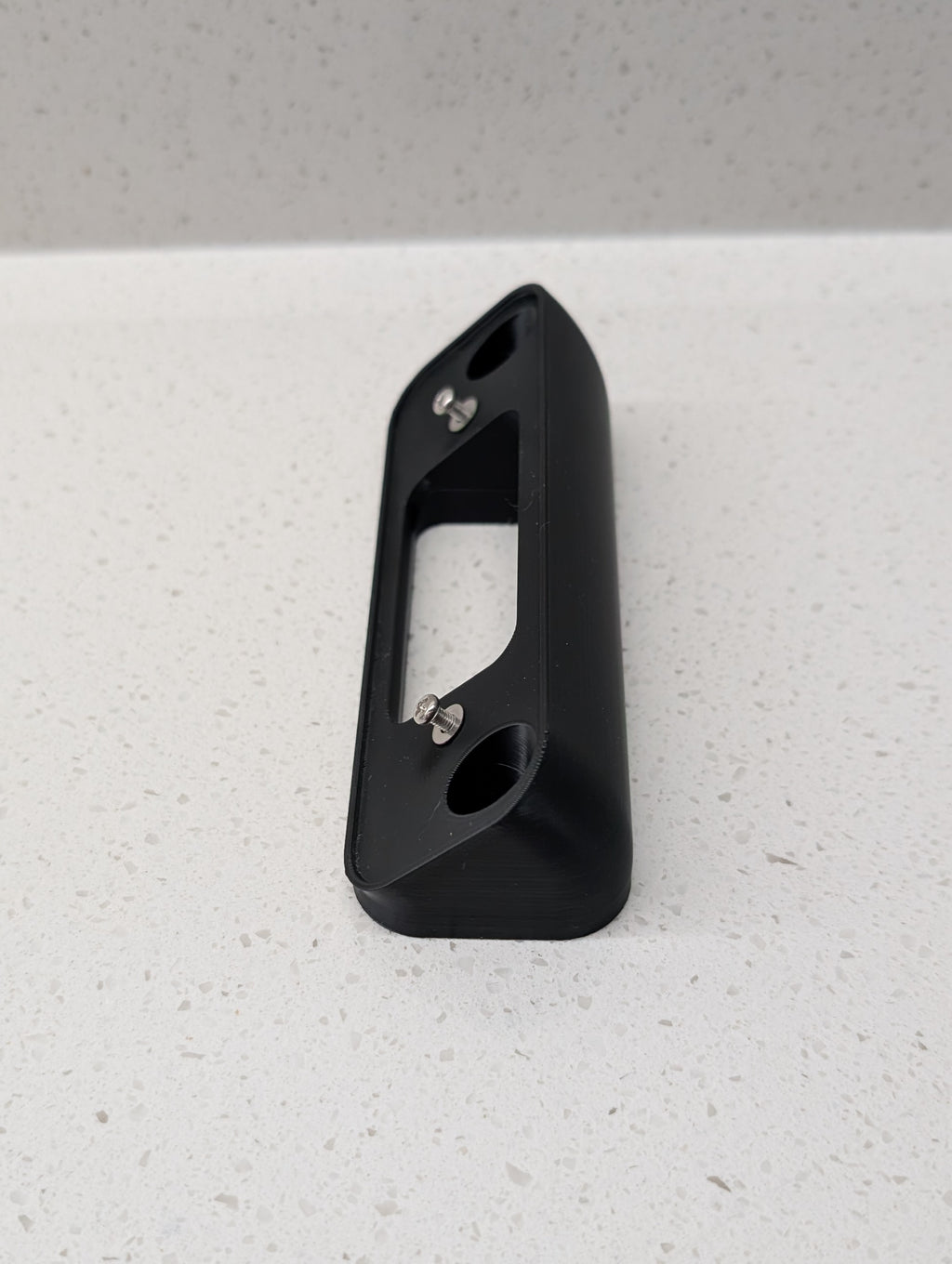 Blink Video Doorbell (2nd Gen) Reversible Angle Mount, in black. Unmounted on work surface.