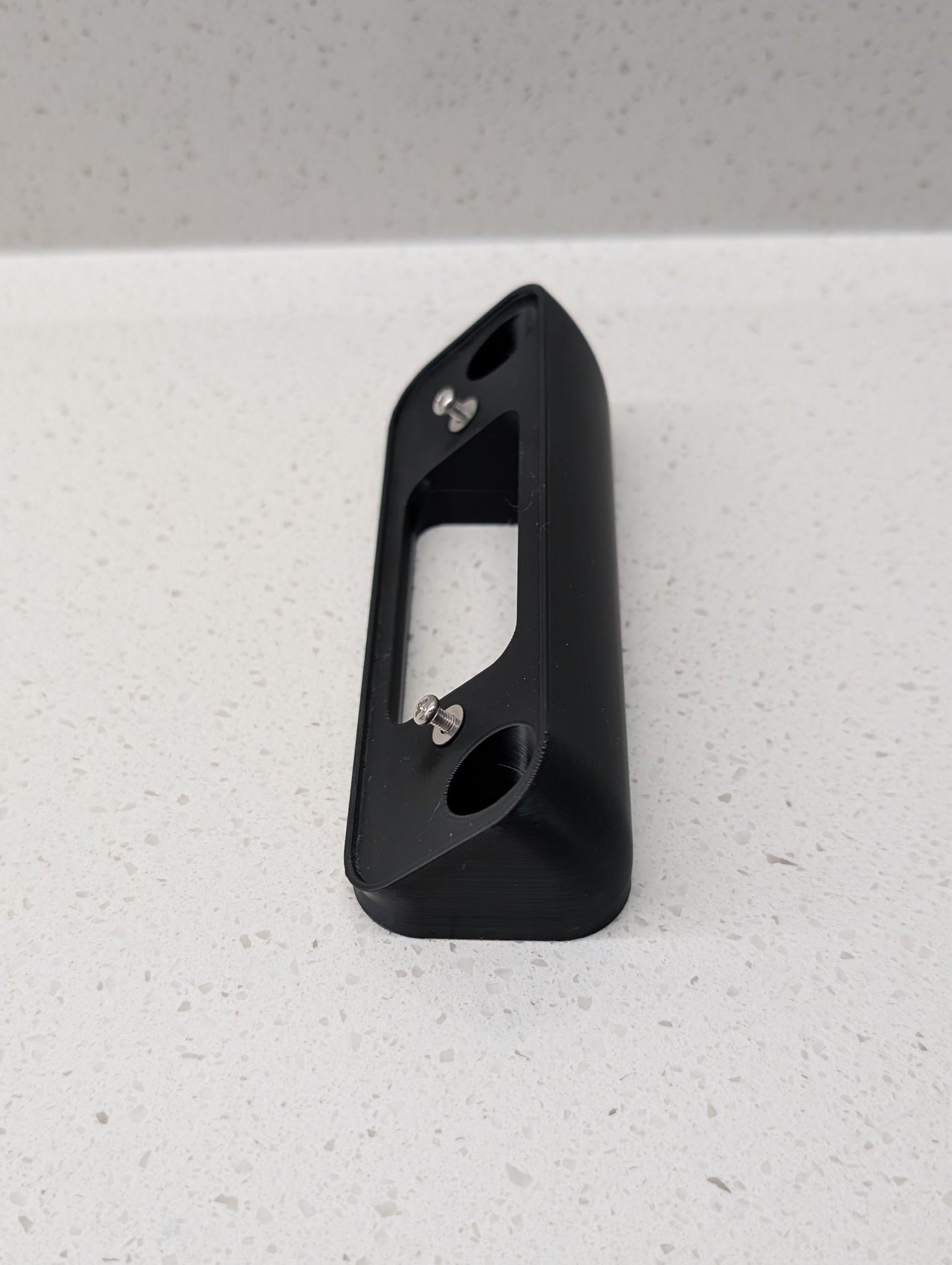 Blink Video Doorbell (2nd Gen) Reversible Angle Mount, in black. Unmounted on work surface.