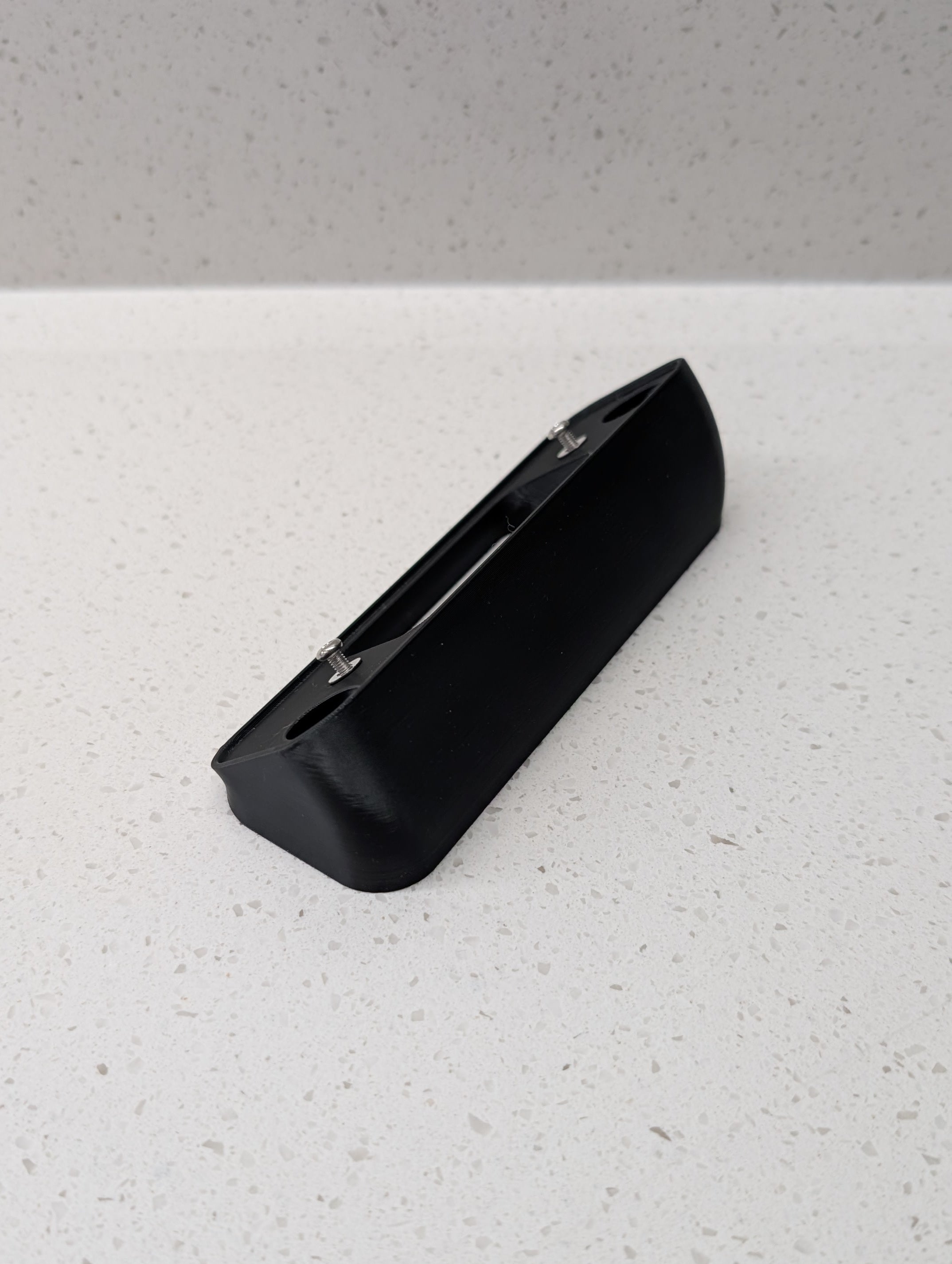Blink Video Doorbell (2nd Gen) Reversible Angle Mount, in black. Unmounted on work surface.