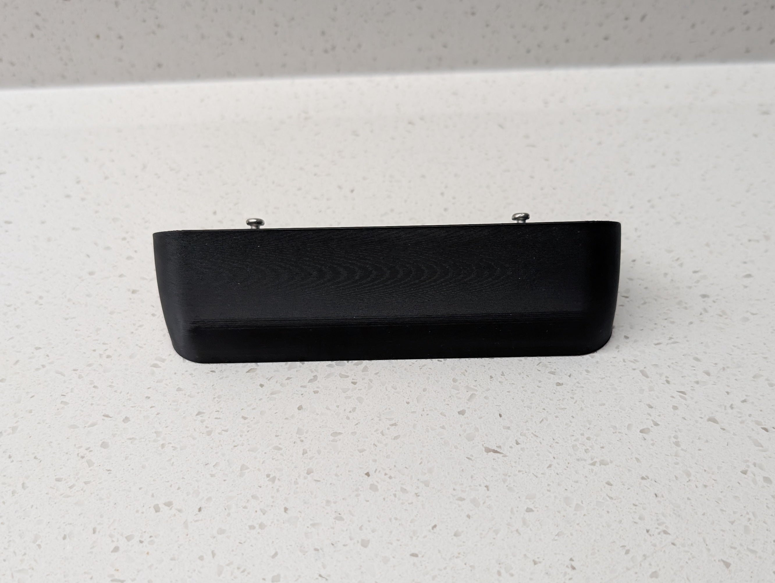 Blink Video Doorbell (2nd Gen) Reversible Angle Mount, in black. Unmounted on work surface.