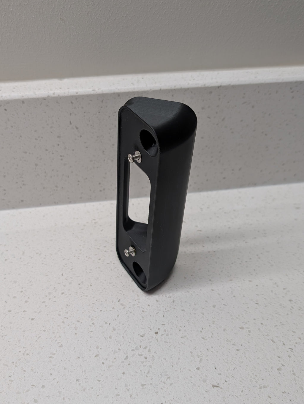 Blink Video Doorbell (2nd Gen) Reversible Angle Mount, in black. Unmounted on work surface.