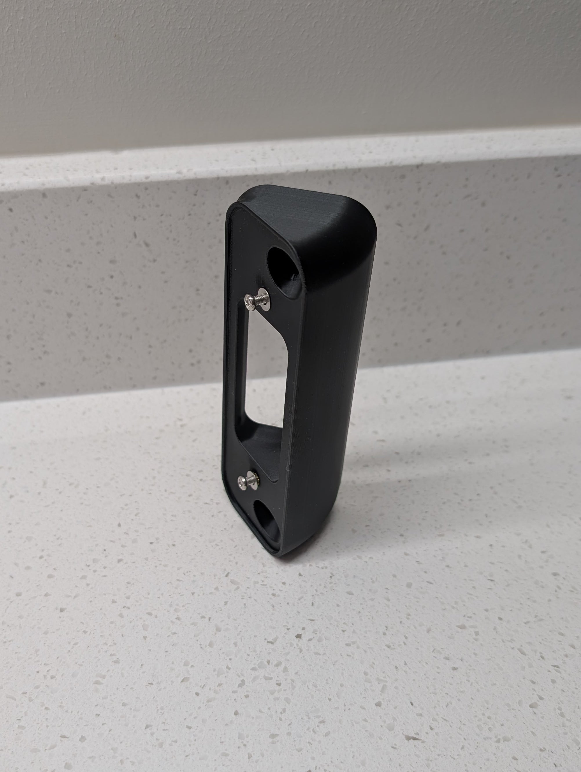 Blink Video Doorbell (2nd Gen) Reversible Angle Mount, in black. Unmounted on work surface.