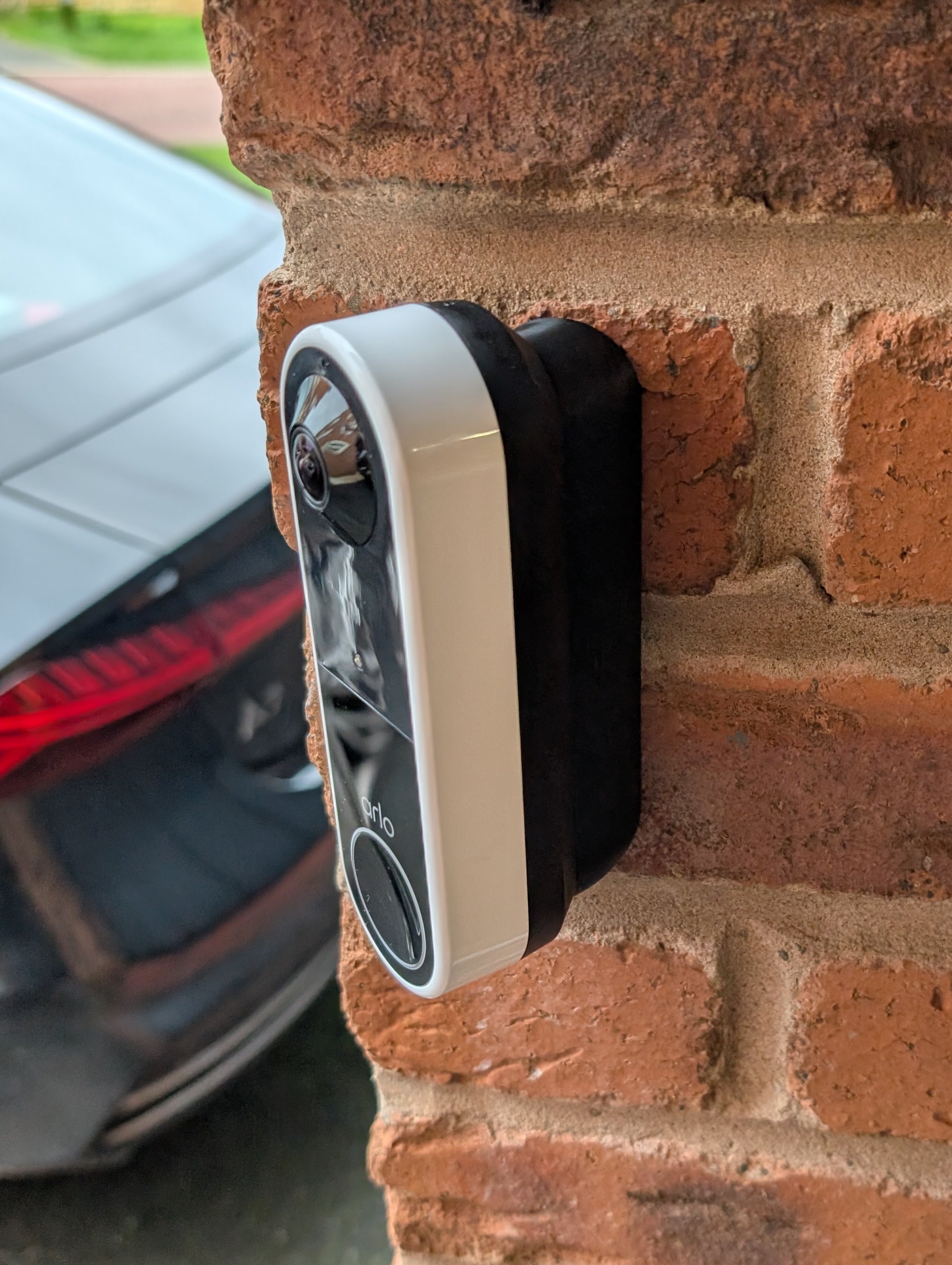 Arlo Essential Video Doorbell Gen 1 Reversible Angle Mount, in black. Mounted on wall.