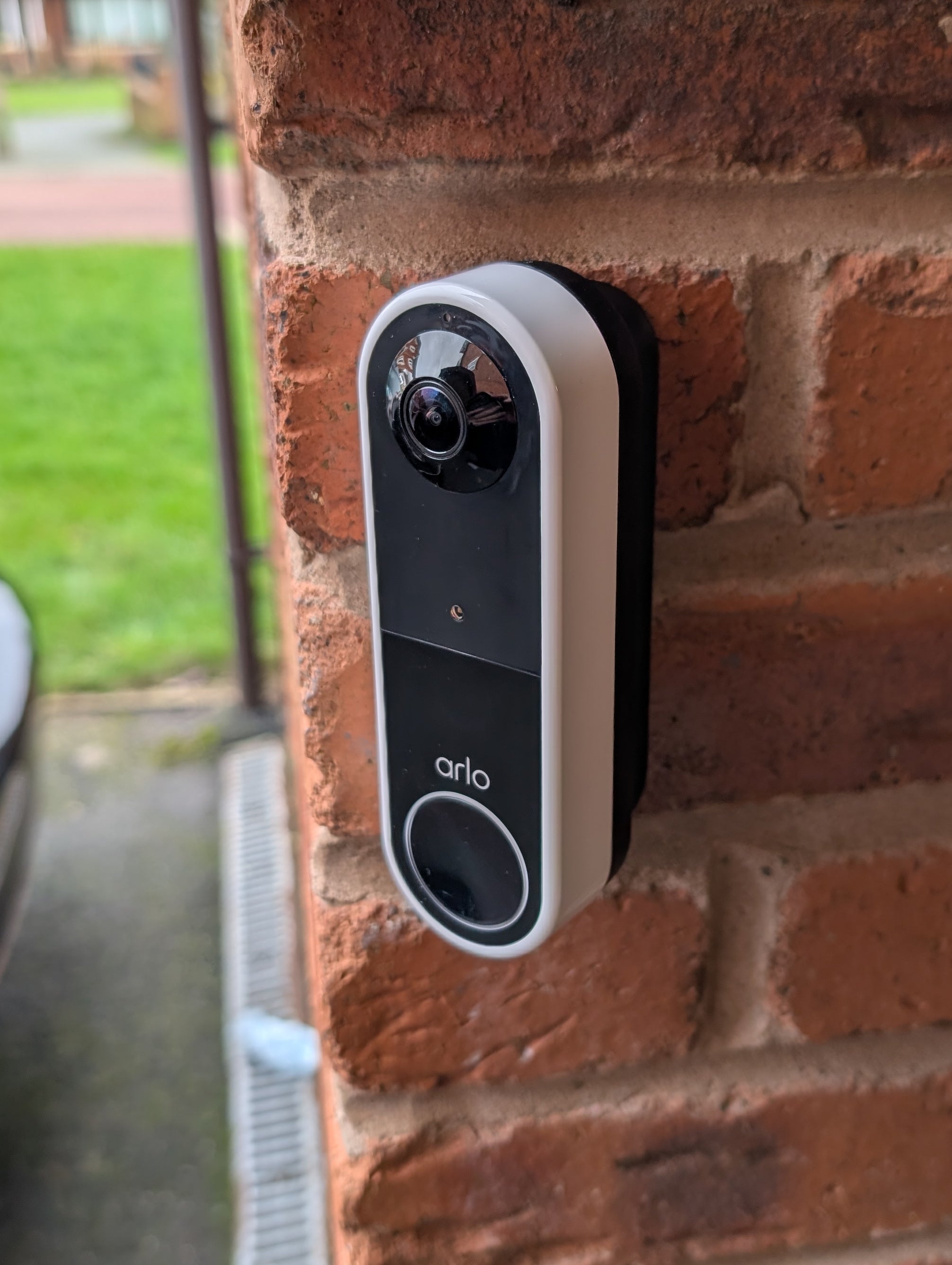 Arlo Essential Video Doorbell Gen 1 Reversible Angle Mount, in black. Mounted on wall.