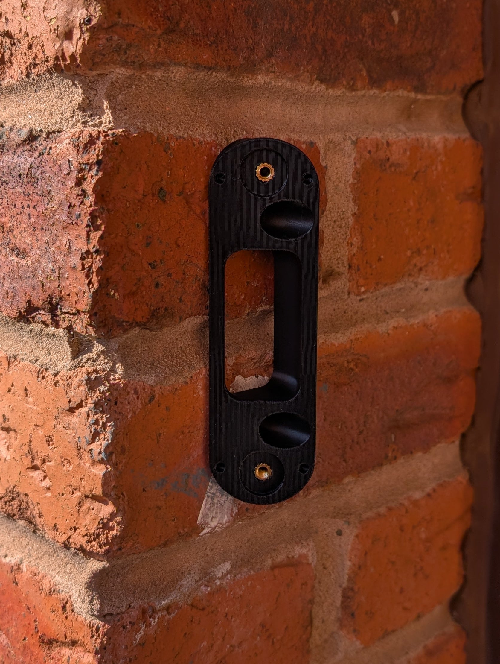 Angled wedge mount for Arlo Gen2 Doorbell, in black.