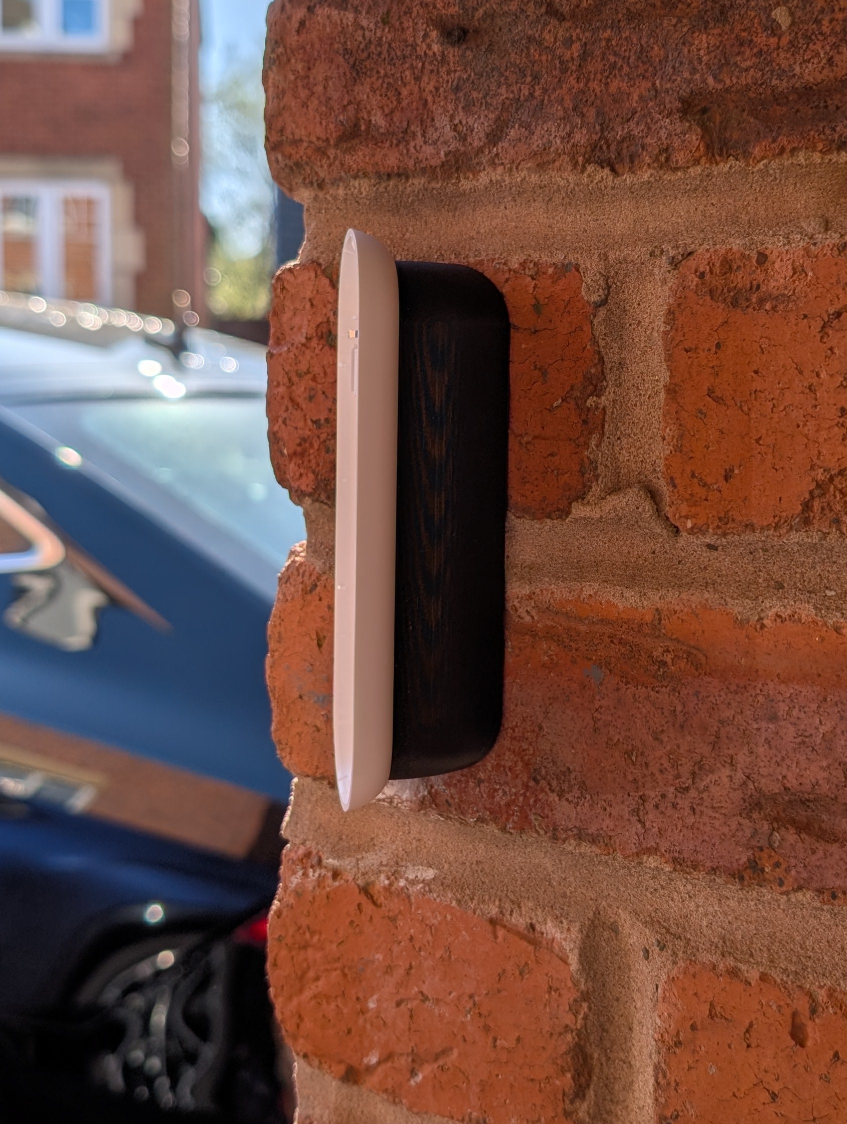 Angled wedge mount for Arlo Gen2 Doorbell, in black.