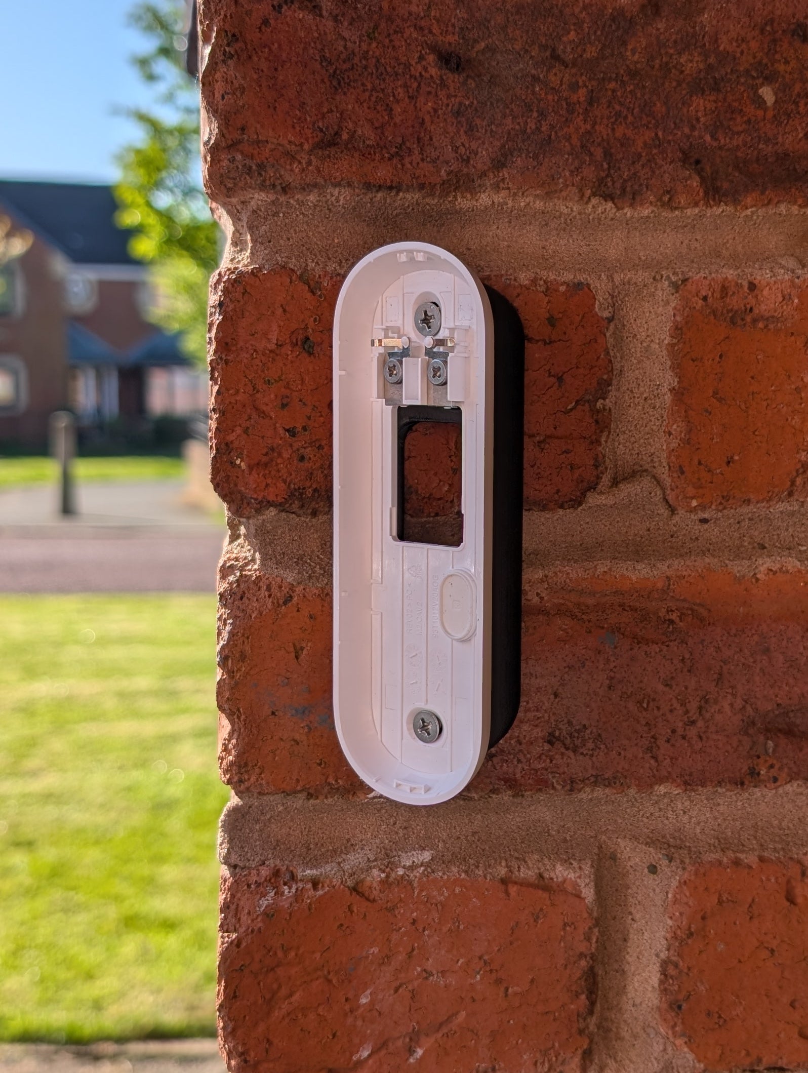 Angled wedge mount for Arlo Gen2 Doorbell, in black.