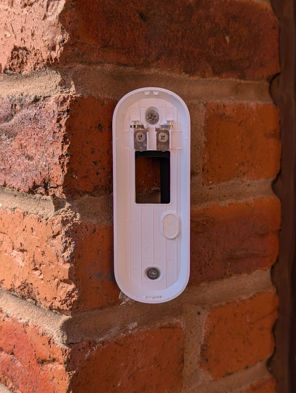 Angled wedge mount for Arlo Gen2 Doorbell, in black.