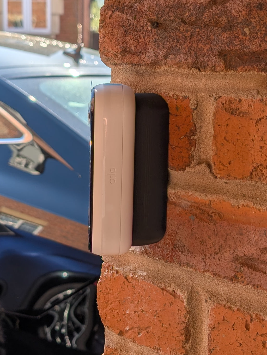 Angled wedge mount for Arlo Gen2 Doorbell, in black.