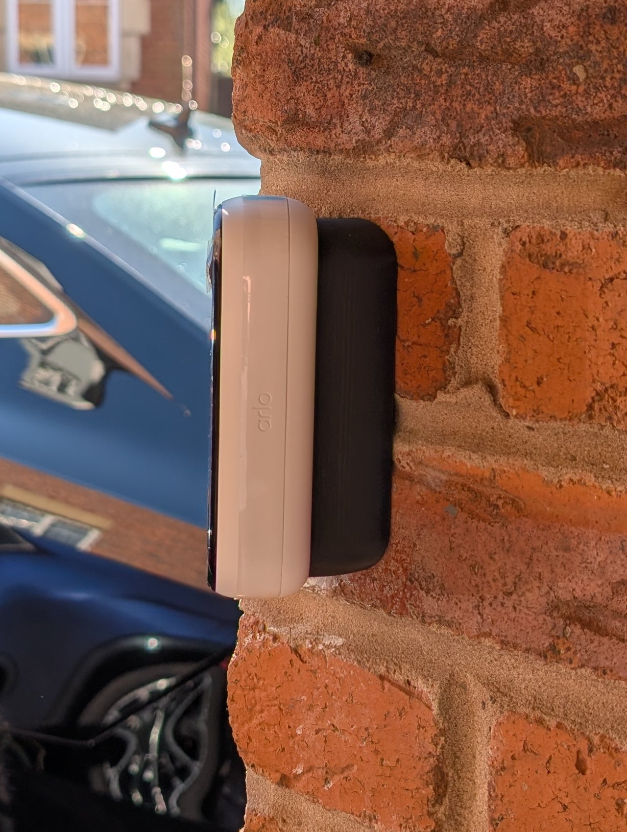 Angled wedge mount for Arlo Gen2 Doorbell, in black.