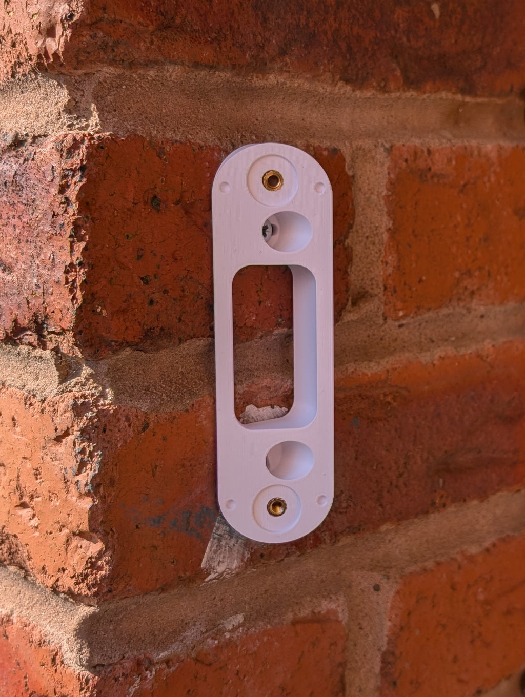 Angled wedge mount for Arlo Gen2 Doorbell, in white.