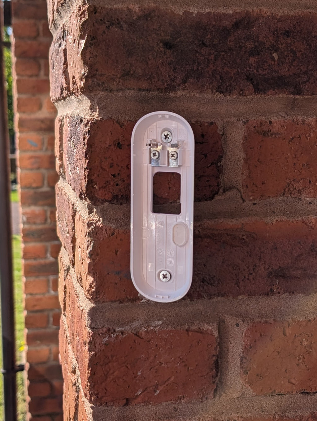 Angled wedge mount for Arlo Gen2 Doorbell, in white.