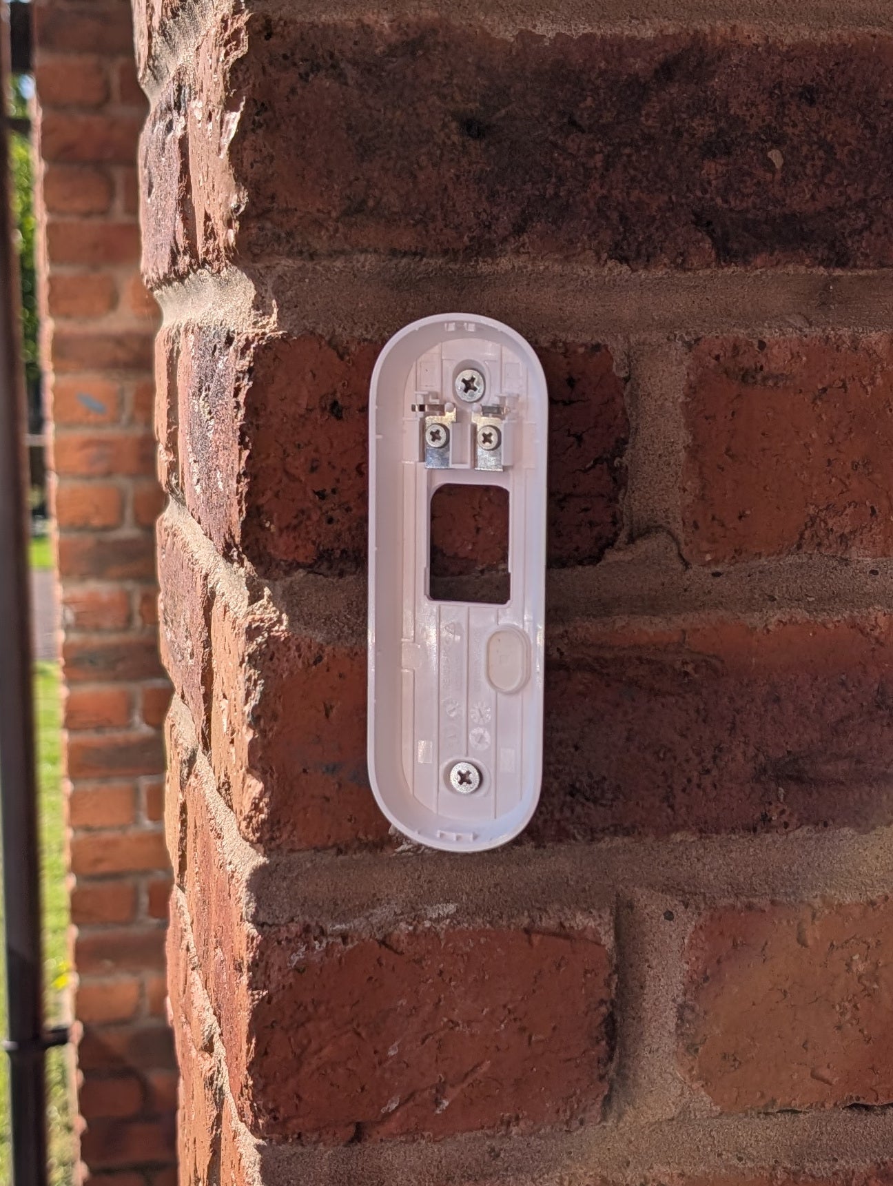 Angled wedge mount for Arlo Gen2 Doorbell, in white.