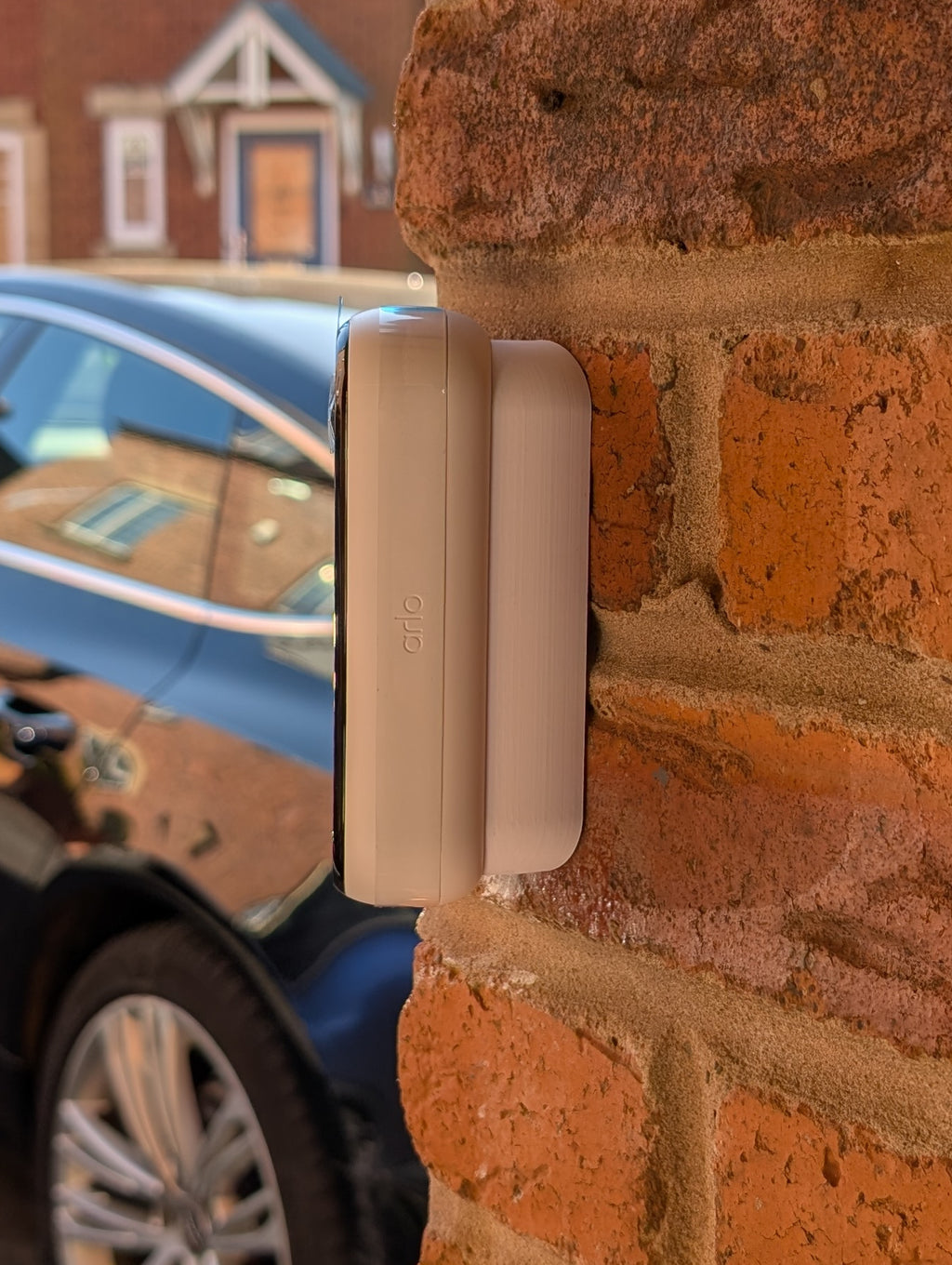 Angled wedge mount for Arlo Gen2 Doorbell, in white.