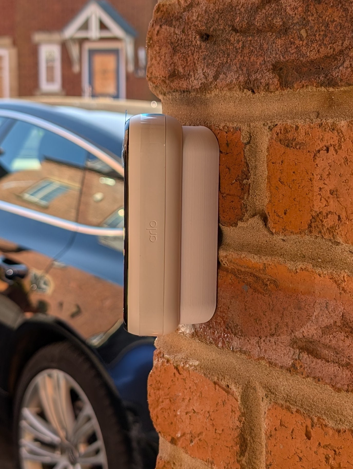 Angled wedge mount for Arlo Gen2 Doorbell, in white.