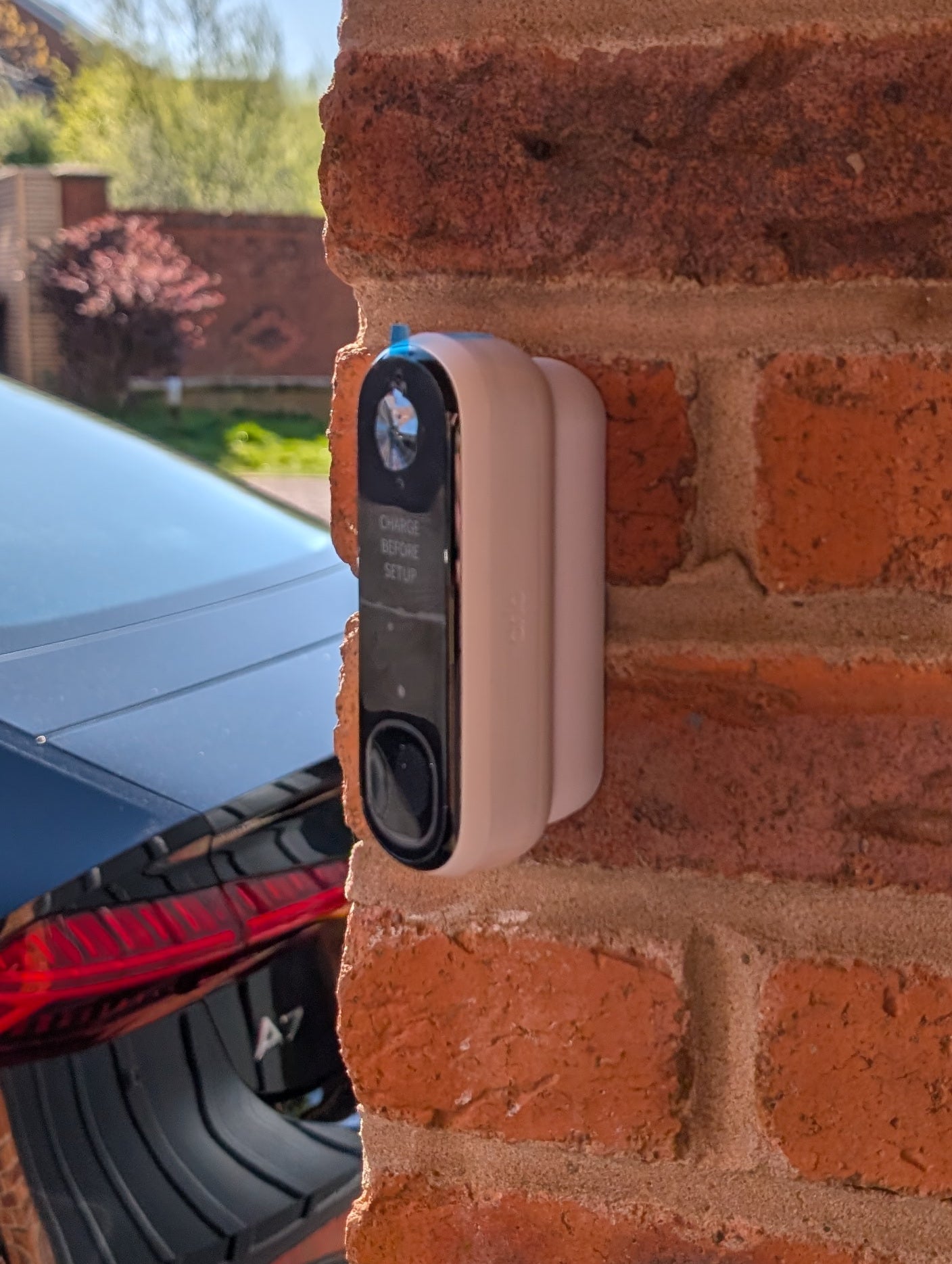 Angled wedge mount for Arlo Gen2 Doorbell, in white.