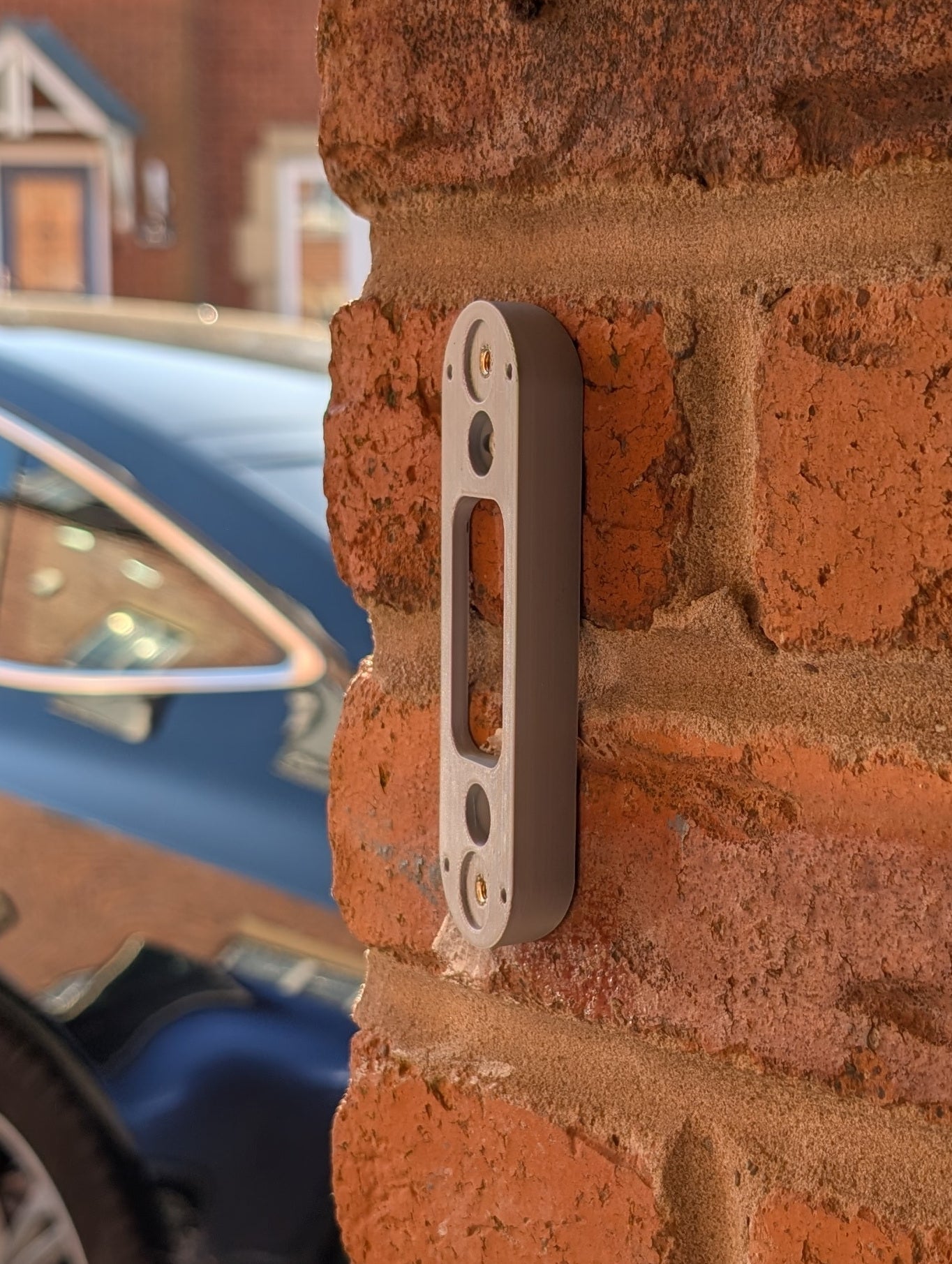 Angled wedge mount for Arlo Gen2 Doorbell, in grey.