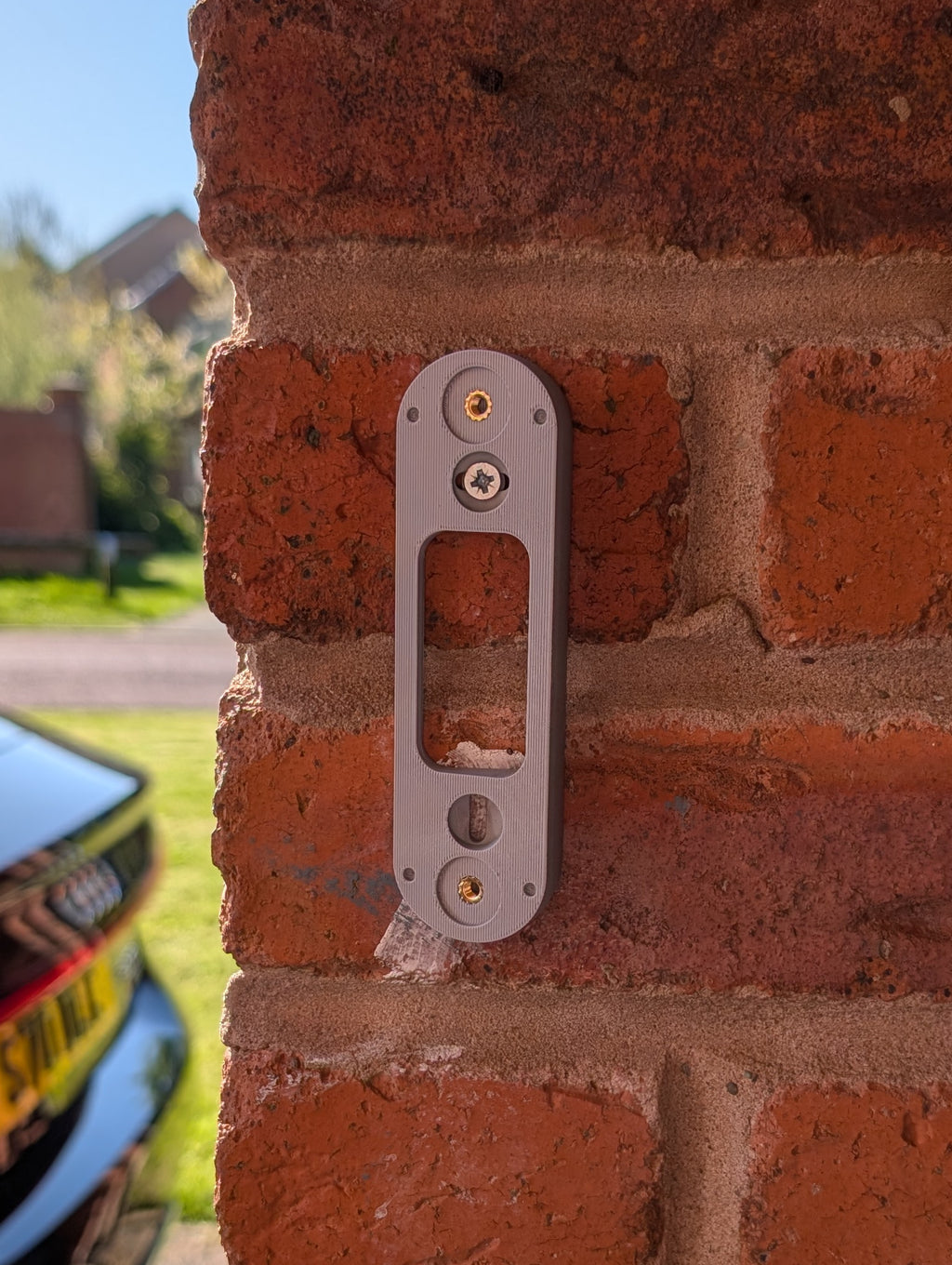 Angled wedge mount for Arlo Gen2 Doorbell, in grey.